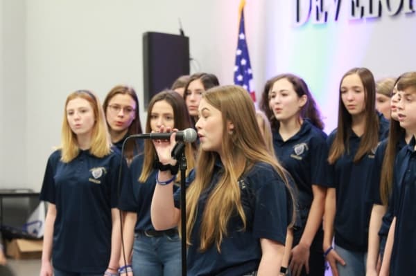The Lake Creek High School choir sang three songs. (Andy Li/Community Impact Newspaper)
