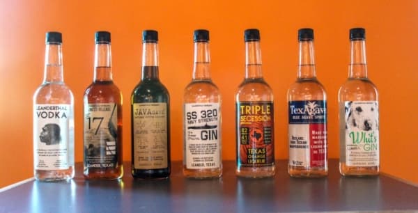 Leanderthal Distilling's seven liquors are showcased in Leanderthal Lounge. (Brian Perdue, Community Impact Newspaper)