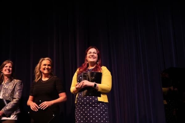 Winners of the 2020 Diversity Leadership Awards stand next to each other at the Plano ISD Proud event. The winner for the individual category was Cailtin Bailey-Garafola (far right), and the group winner was Hedgcoxe Elementary School staff and PTA (left). (Liesbeth Powers/Community Impact Newspaper)