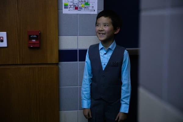 Alex Zhu smiles as he watches the audience react to his video performance of his writing contest piece. Each of the writing contest winners were recorded reading their work in their schools. (Liesbeth Powers/Community Impact Newspaper)