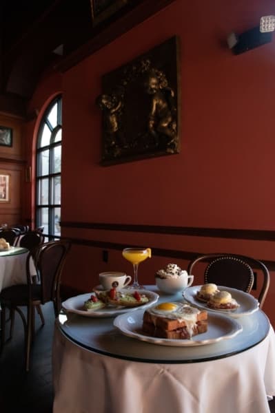 Dining in for breakfast: 3 dishes to try (left to right) Avocado toast ($10), Croque-Madame ($11.50), Eggs Benedict ($12); Drinks (left to right) Latte ($4.90), Mimosa ($8), Intermezzo Hot Chocolate ($6.95) (Liesbeth Powers/Community Impact Newspaper)