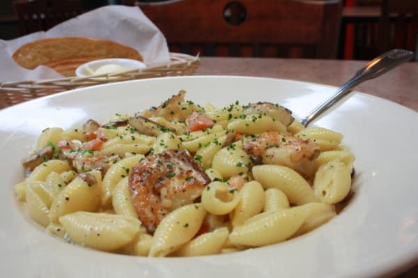 Pasta Dylan is made with sauteed shrimp in a rich vermouth cream sauce with mushrooms, diced tomatoes, green onions and shell pasta. (Shawn Arrajj/Community Impact Newspaper)