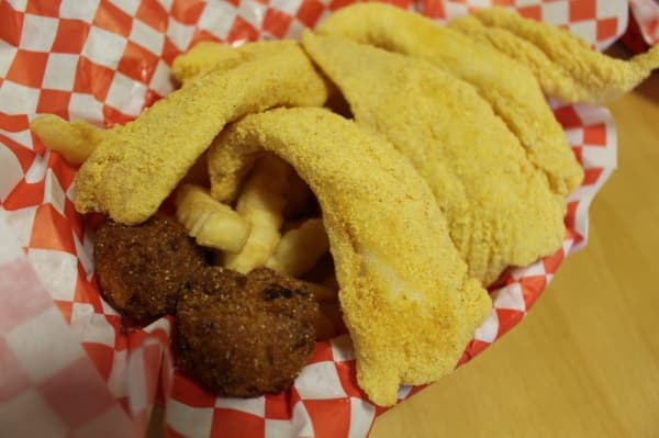 Regular fish ($8.50) is a dish with five pieces of cornmeal-crusted catfish, served with fires and hushpuppies.