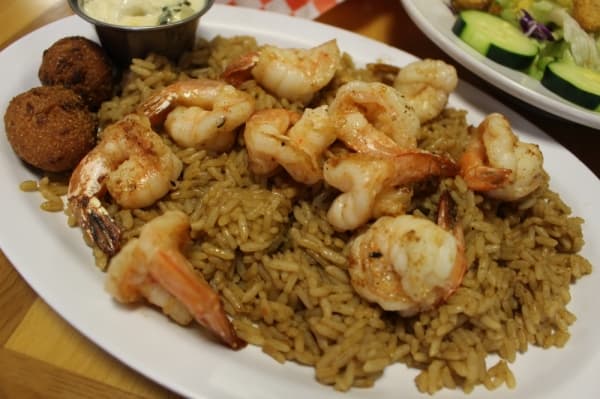 




Blackened shrimp ($14.50): Grilled shrimp are served with rice, a side salad, hushpuppies and captain sauce.