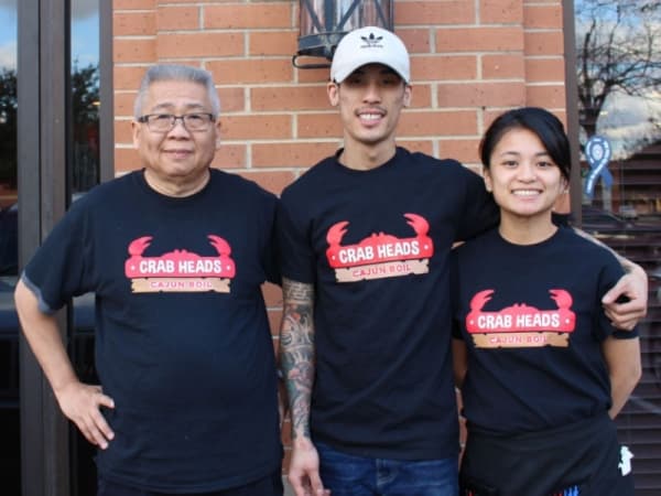 David Le (center) opened Crab Heads Cajun Boil with his wife Julia Tran and restaurant manager Tommy Le.