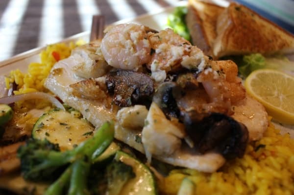 The Mahi Irene ($28.99) features a Mahi fillet topped with lump blue crab, shrimp, mushrooms and garlic butter sauce on a bed of rice. (Kara McIntyre/Community Impact Newspaper)