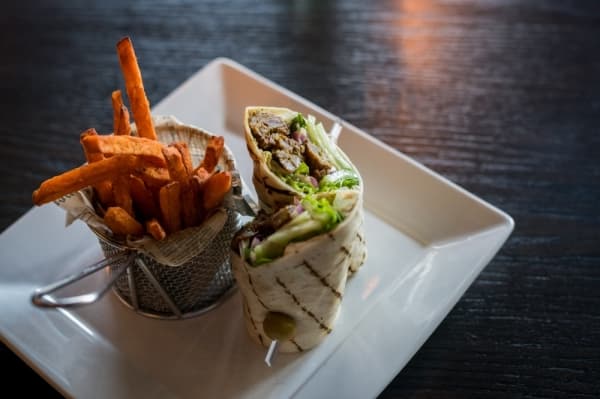 Beef satay wrap ($10.95): Grilled steak, lettuce, cucumbers, red onions and peanut sauce are served with sweet potato fries.