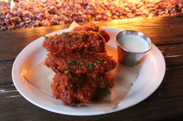 The Tavern Wings ($10) are bone-in and come in three flavors: buffalo, garlic parmesan and rye maple bacon. (Photo by Anna Herod/Community Impact Newspaper)