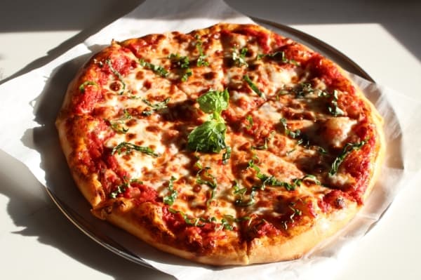 Keeping it Simple Pizza ($10) contains tomato sauce, fresh mozzarella, fresh basil and a homemade crust. (Andrew Christman/Community Impact Newspaper)