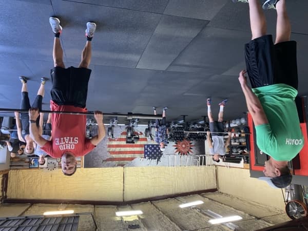 Lakeway Elite Fitness coach Casey Stein (left) leads his CrossFit class. 