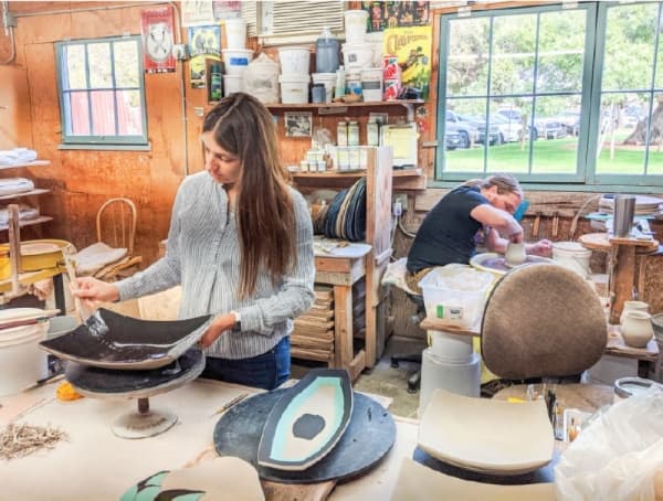 Angie and Kyle White work in The Barn's studio (Warren Brown/Community Impact Newspaper).