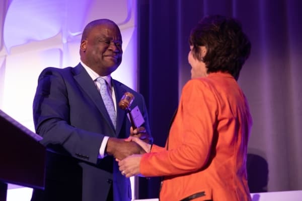 LaMonte Thomas, 2019 chair of the Plano Chamber of Commerce, hands the gavel to Lissa Smith as her induction into her role as 2020 board chair. (Liesbeth Powers/Community Impact Newspaper)