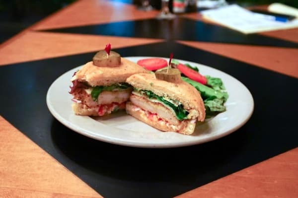 Not Fried Chicken ($10.95): breaded chicken, red onions, tomatoes, pepper jack cheese, mixed greens and chipotle aioli on jalapeno cheddar sourdough