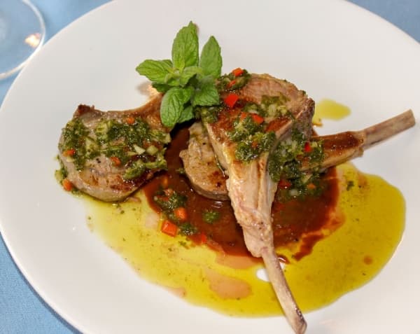 The Lambchop Lollipops ($11-$22) dish comprises of New Zealand lamb, mint-rosemary oil and chimichurri sauce. (Adriana Rezal/Community Impact Newspaper)