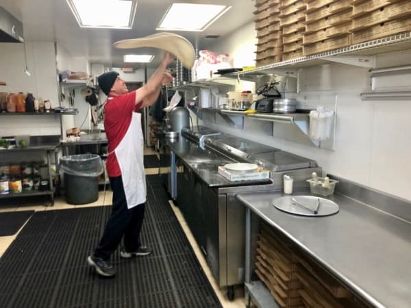 Abed Yaghi makes a margherita pizza. (Sally Grace Holtgrieve/Community Impact Newspaper)