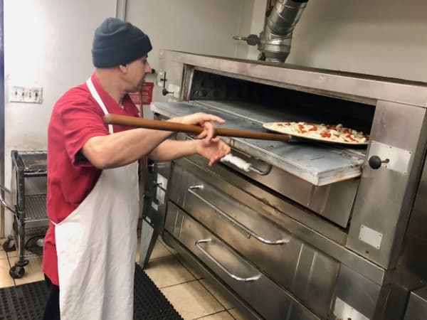 Abed Yaghi makes a margherita pizza. (Sally Grace Holtgrieve/Community Impact Newspaper)