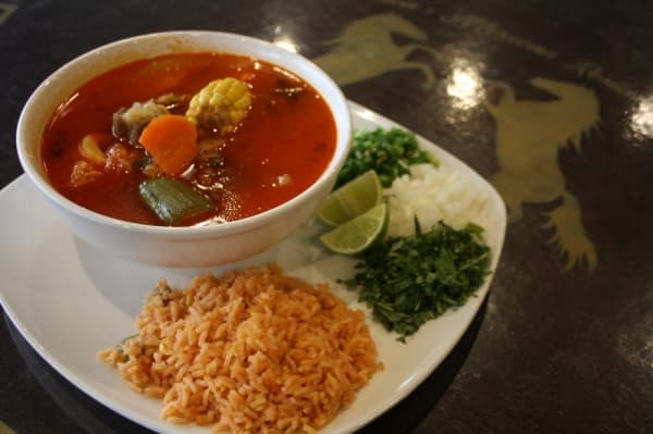 Caldo de Res is a beef soup freshly made with carrots, corn, potatoes and chayote and is served with rice, cilantro, jalapenos, onions and tortillas. (Shawn Arrajj/Community Impact Newspaper)