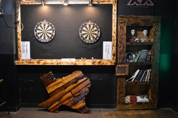 The Local Outpost owner Kevin Hibbs built the bar’s fixtures, decorations and interior all by hand. The natural wood interior gives the bar a special aesthetic that customers distinctly remember, Hibbs said. (Iain Oldman/Community Impact Newspaper)