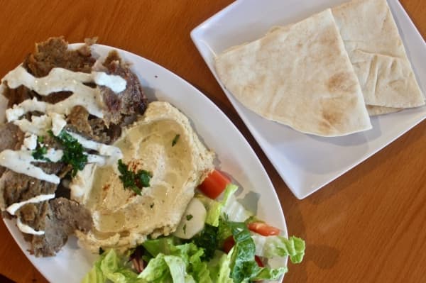 Customers can pick any protein, such as lamb shawarma, and two sides to create a plate. (Amy Denney/Community Impact Newspaper)