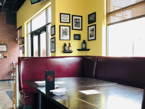The ‘Godfather booth’ at Wise Guys Pizzeria pays homage to the uncle and godfather of owner Kevin McNamara. (Ian Pribanic/Community Impact Newspaper)