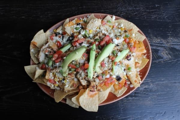 The L.A. Veggie Nachos ($8.99) are topped with avocado slices. (Photo by Anna Herod/Community Impact Newspaper)