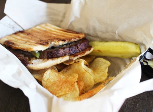 The Philly cheesesteak panini ($8.99) features sliced beef, grilled onions and bell peppers. (Dylan Sherman/Community Impact Newspaper)