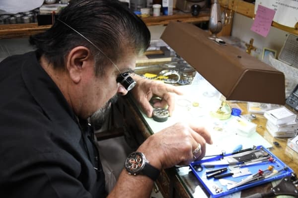 Homero Capetillo leans in to take a closer look at the timepiece's mechanisms.(Hunter Marrow/ Community Impact)
