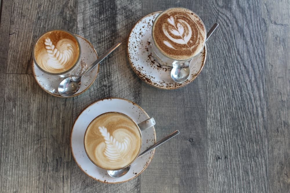 The piccolo latte (left), the chai latte (bottom) and the flat white (right) are the Grind's most popular coffees. (Elizabeth Uclés/Community Impact Newspaper)
