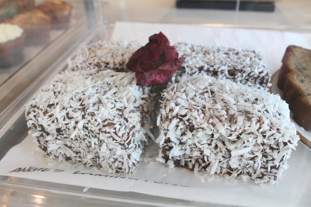 The Aussie Grind offers lamingtons, an Australian pastry. They are vanilla butter cakes rolled in chocolate and coconut. (Elizabeth Uclés/Community Impact Newspaper)
