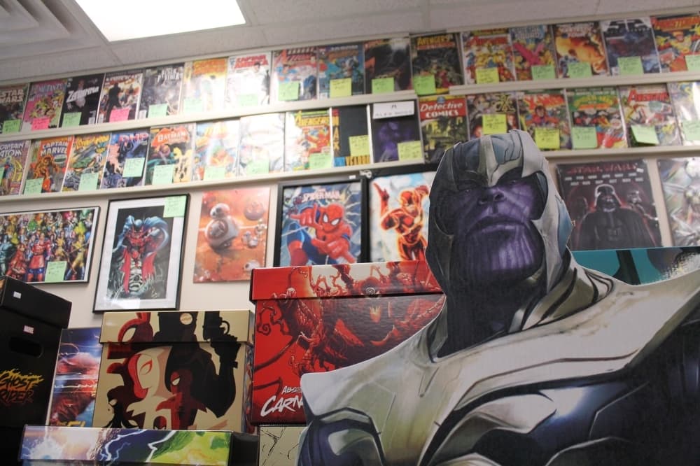 A cardboard cutout of Thanos stands in front of a wall of classic comic books. (Photos by Lindsey Juarez Monsivais/Community Impact Newspaper)