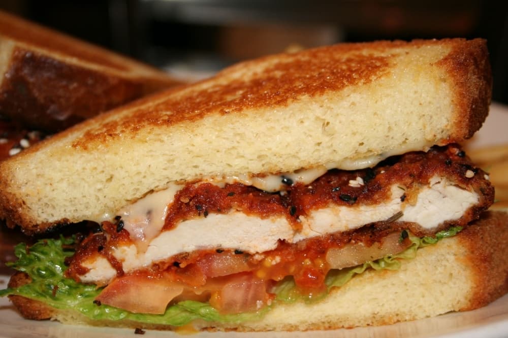 One of owner Benny Polisi’s personal favorites is the buffalo chicken burger ($8.99), which he makes with Swiss cheese, lettuce, tomatoes and brioche bread. (Renee Yan/Community Impact Newspaper)