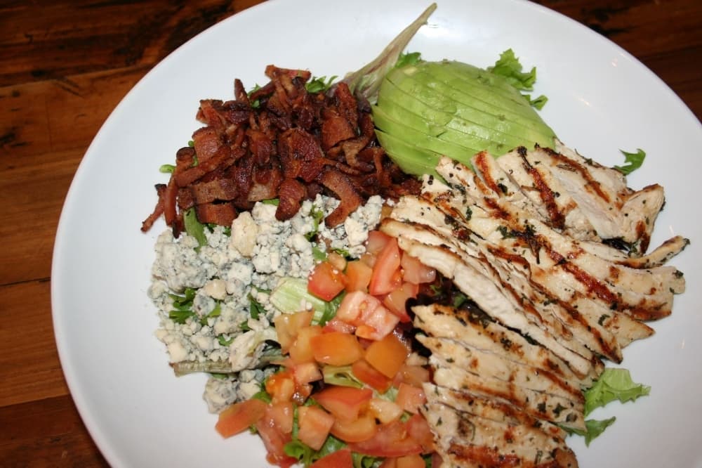 Customers can also order from Benny’s selection of salads, including the Cobb salad ($9.99), which includes grilled chicken, bacon, avocado, tomatoes and bleu cheese crumbles. (Renee Yan/Community Impact Newspaper)