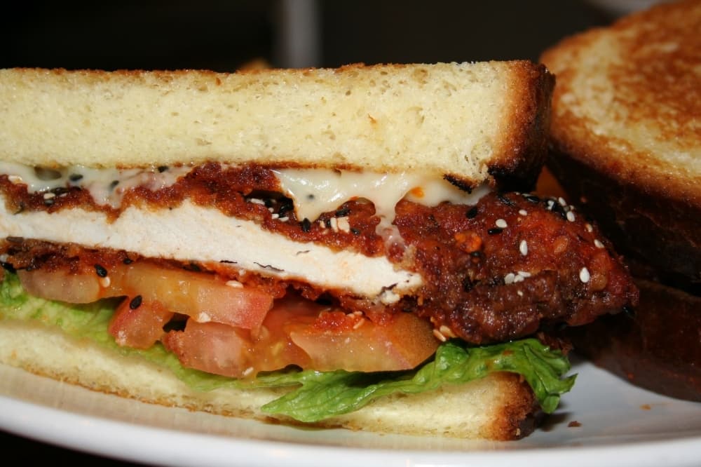 One of owner Benny Polisi’s personal favorites is the buffalo chicken burger ($8.99), which he makes with Swiss cheese, lettuce, tomatoes and brioche bread. (Renee Yan/Community Impact Newspaper)