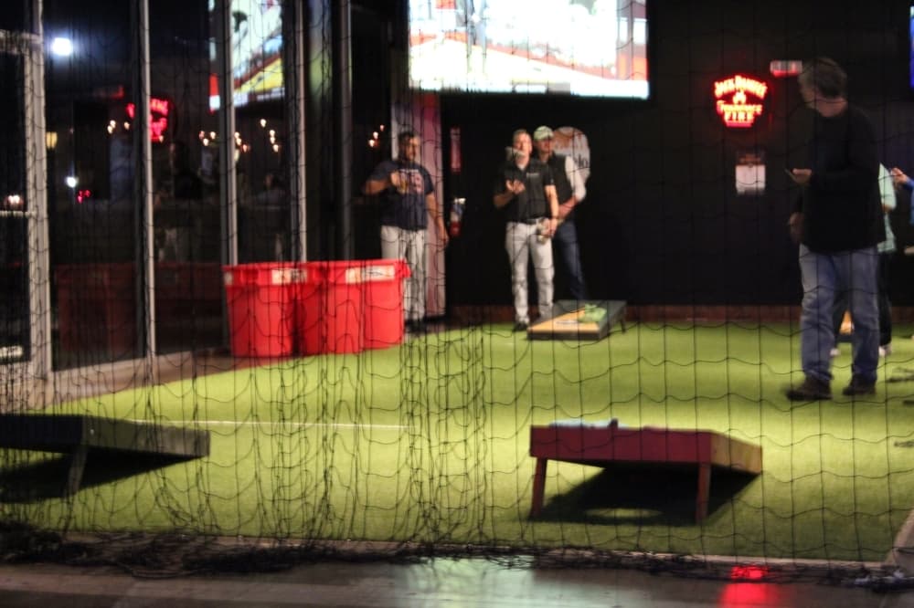 In addition to pool tables, dart boards and arcade game machines, Mak's Sports Bar + Grill offers a netted area for trash can pong and cornhole. (Adriana Rezal/Community Impact Newspaper)