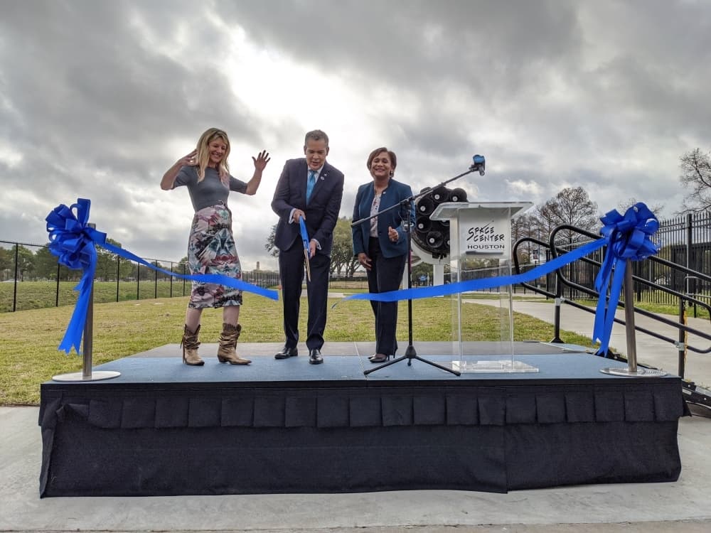 Space Center Houston CEO William Harris cuts a ribbon March 12 to officially open the Falcon 9 rocket booster exhibit at the center. (Jake Magee/Community Impact Newspaper)
