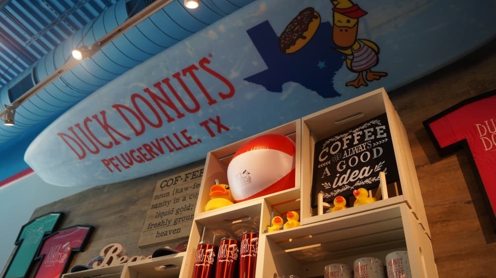 Its Pflugerville storefront is decorated with Pflugerville-themed items, and includes T-shirts and coffee mugs available for purchase. (Kelsey Thompson/Community Impact Newspaper)