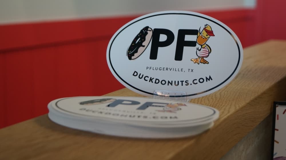 In traditional Pflugerville fashion, "Pf" stickers are available for purchase—this time, adorned with a doughnut and a duck.(Kelsey Thompson/Community Impact Newspaper)