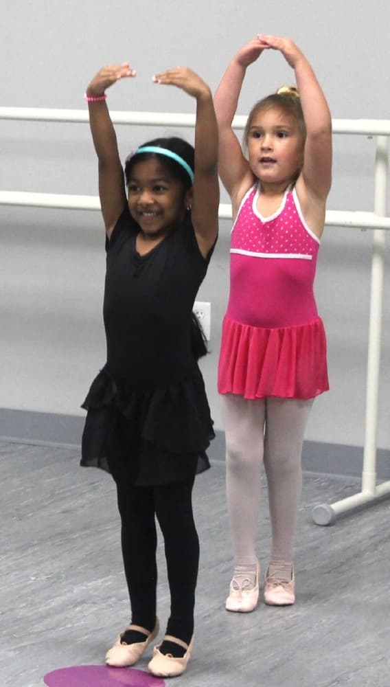 Students in the beginner ballet class work on dance moves. (Brian Perdue/Community Impact Newspaper)