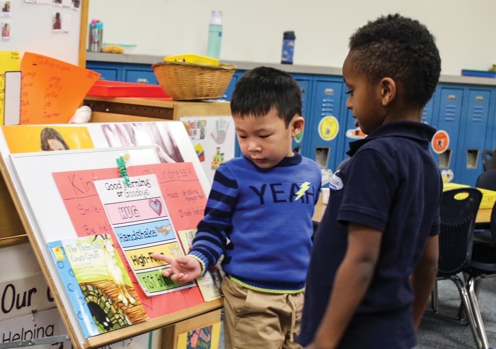 Teachers say learning social skills is emphasized in pre-K. Here, two students choose how to greet one another. (Brian Perdue/Community Impact Newspaper)•