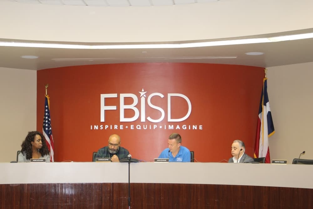 From left: Trustee Addie Heyliger, Superintendent Charles Dupre and board President Jason Burdine attended the March 13 emergency board meeting in person. All other trustees participated via telephone conference. (Claire Shoop/Community Impact Newspaper)