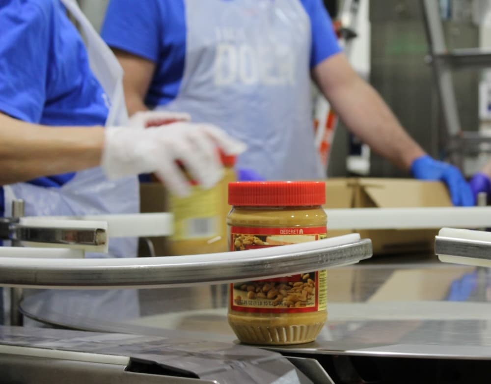Volunteers work four-hour shifts. Tasks include adding ingredients, lid-placing and packaging. (Adriana Rezal/Community Impact Newspaper) 
