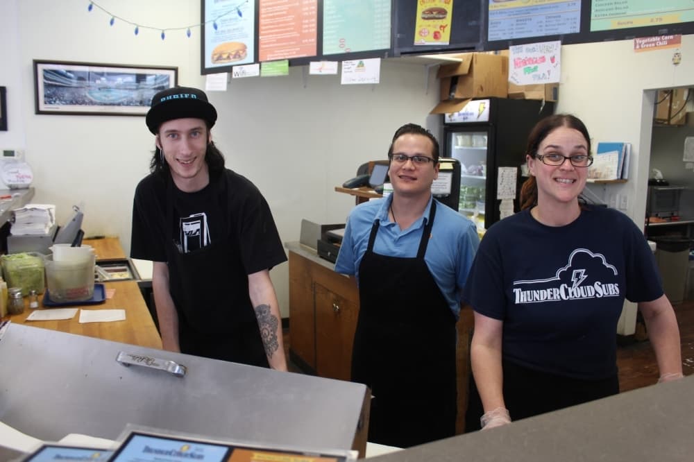 Kameron McCormick, area manager Nolan Moreno and Sara Peak serve customers during lunch March 16. (Brian Perdue/Community Impact Newspaper)