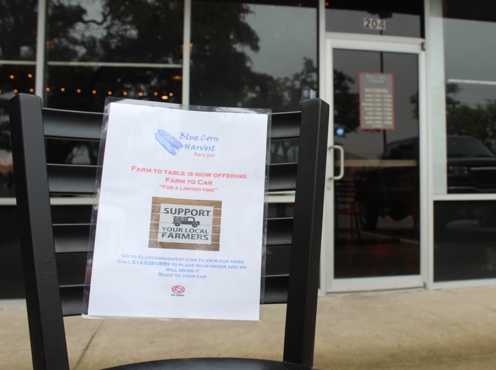 Two parking spaces are reserved for curbside customers outside Blue Corn Harvest. (Brian Perdue/Community Impact Newspaper)
