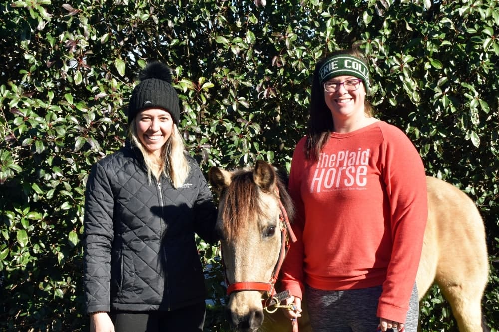 Barn manager Kori Delcambre (left) and instructor Anna Lowell teach lessons at Windmill Stables. (Makenzie Plusnick/Community Impact Newspaper)