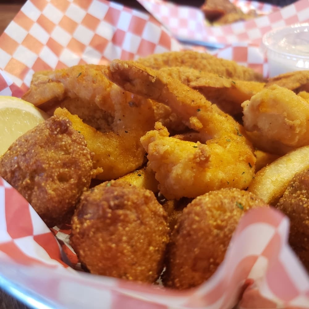 Fried catfish and shrimp basket with hush puppies and fries ($12.95) (Ali Linan/Community Impact Newspaper)