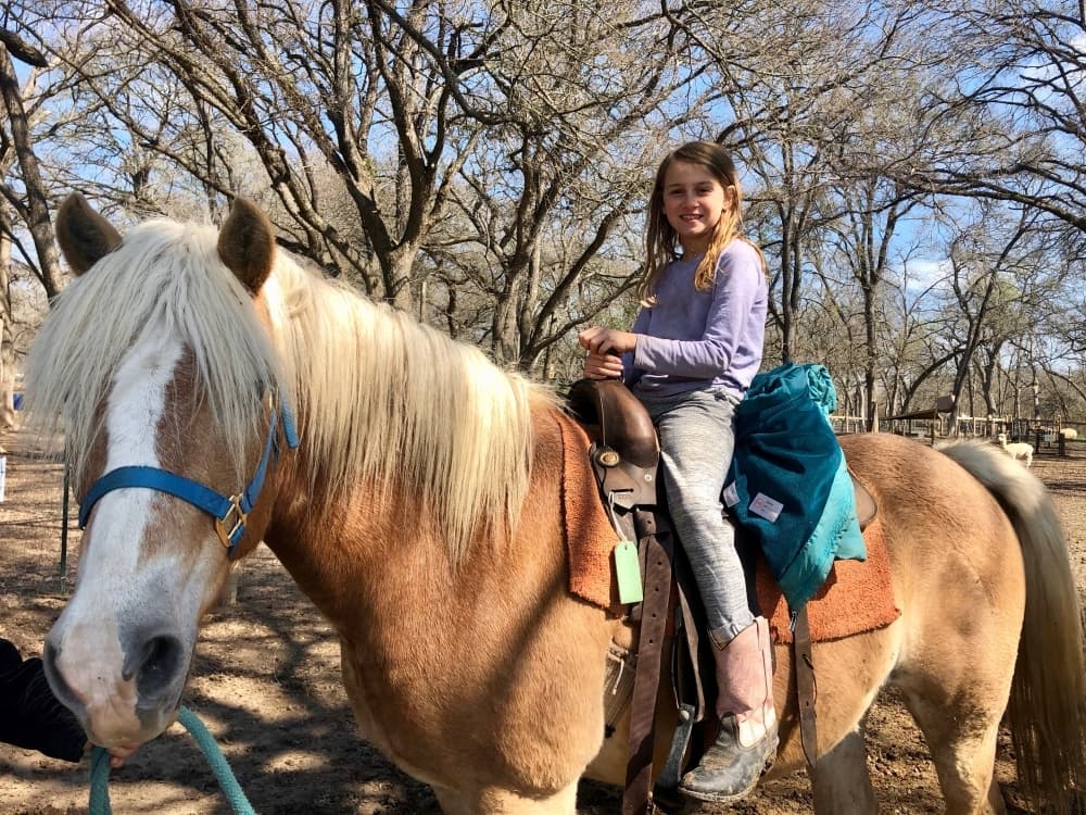 Emma Meredith rides a pony. (Sally Grace Holtgrieve/Community Impact Newspaper)