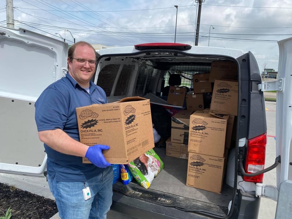 COVID-19 North Texas Relief group member Joel Upton loads supplies into a van on March 18. (Courtesy Adrianne Hudson)