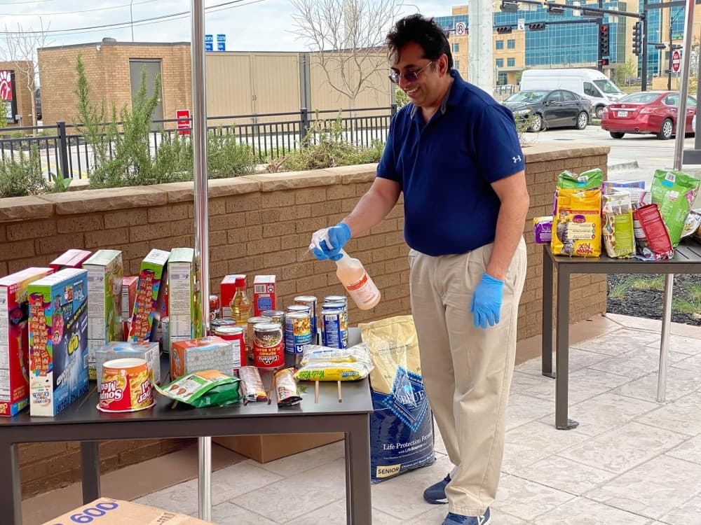 Nirav Desai disinfects supplies collected March 18 for a senior living facility in Denton County by the COVID-19 North Texas Relief group. (Courtesy Adrianne Hudson)