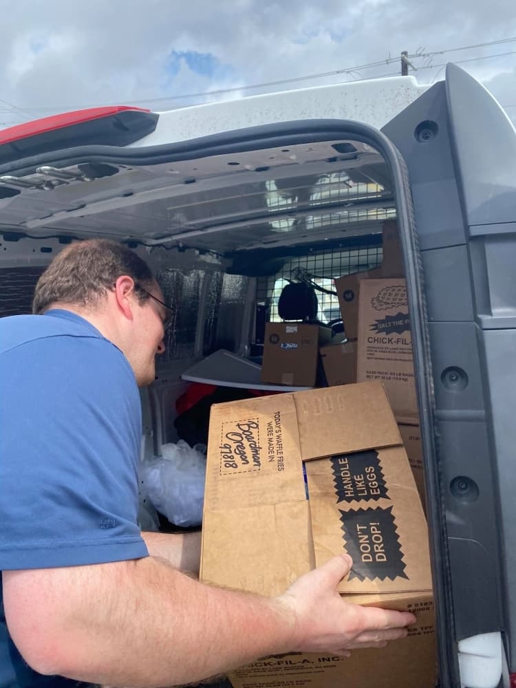 COVID-19 North Texas Relief group member Joel Upton loads food collected March 18 for a senior living facility in Denton County. (Courtesy Adrianne Hudson)