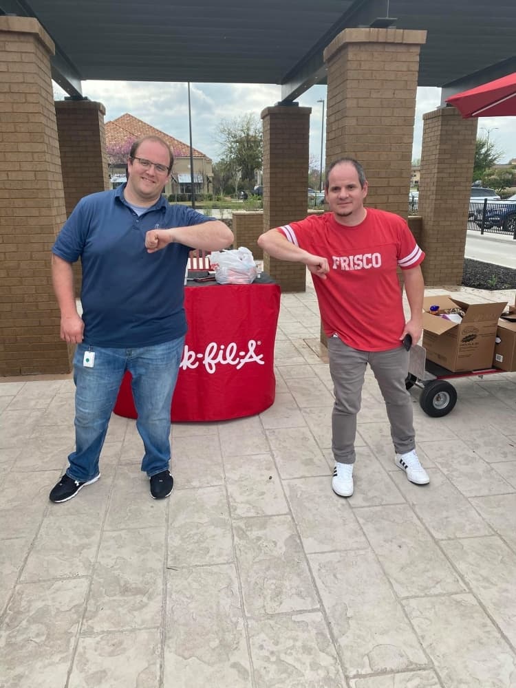 Group founder Greg Danson, right, greets Joel Upton at the Chick-fil-a collection site on March 18. (Courtesy Adrianne Hudson)